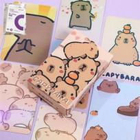 Capybara Poka 50 lapų saugojimo albumas, pridedamas su mielomis kapibaros personažų kortelėmis