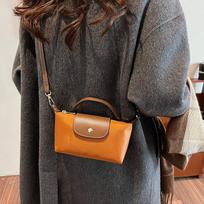 Retro mada universali sprogimas 2025 m. pavasaris ir vasara moteriškos rankinės per petį crossbody rankoje nešiojama aukščiausios klasės nailoninė koldūno rankinė 17*5*9 ruda