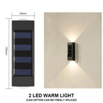Saulės sieninis lauko šviestuvas 2LED šiltai šviesai atsparus vandeniui viršutinis ir apatinis šviesą skleidžiantis balkonas, kiemas, sodo dekoravimo lempa, sieninė plovimo lempa geltona