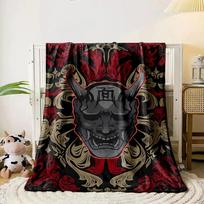 A demonic mask centerpiece with ornate red and beige swirling patterns. for all seasons blanket lunch break throw gift 80cm x 120cm