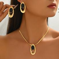 Gold Tone Oval Pendant Necklace and Earrings Set with Smooth Black Oval Inlay and Textured Metal Frame for Women Fashion Jewelry One Size