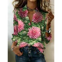 The lady wears a lush green long-sleeved button-down blouse, adorned with a pink lily flower pattern, exuding feminine charm. S