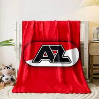 A bold  AZ  logo in black, over a red and white diagonal background. for all seasons blanket lunch break throw gift 80cm x 120cm