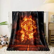 A fiery Manchester United logo emerges against smoke and a dark background. for all seasons blanket lunch break throw gift 80cm x 120cm