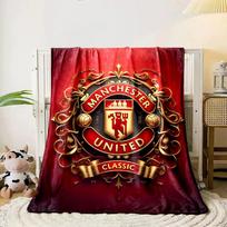 The pattern features an ornate, golden crest with  Manchester United.  for all seasons blanket lunch break throw gift 80cm x 120cm