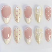 almond epoxy press-on nails, nude yellow white tones with polka dot, bow and pearl decor. Glossy French full-cover removable nails for daily wear 30pcs