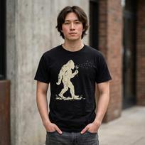 Blowing Wishes Funny Bigfoot T-Shirt; Vintage Sasquatch Dandelion Art; Retro Cryptid Nature Tee 2XL