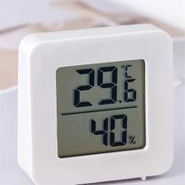 Miniature indoor temperature and humidity gauge, electronic digital display, shows both humidity and temperature.