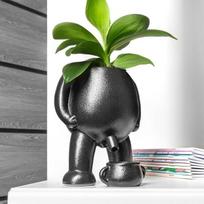 Flower pot urinating man with water collection basin