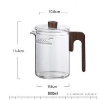 Karščiui atsparus žaliosios arbatos stiklinis arbatinukas su pusmėnulio formos kvapniosios arbatos filtru, medine rankena, arbatai ruošti, stiklinis puodas, arbatos reikmenys white
