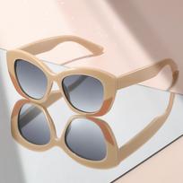 New artistic style sunglasses with cat-eye color contrast embellishment exude a sense of high-end travel sunglasses beige