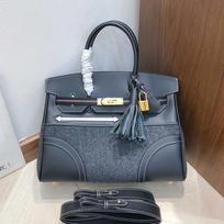 Haute couture version first layer swift cowhide splicing felt, contrasting leather handheld women's bag shoulder messenger bag 20cm juoda