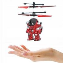 Skraidantis raudonas robotas žaislas, levituojantis virš rankos