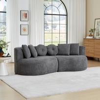 Dviejų dalių, modulinė, lenkta šenilinė sofa tamsiai pilkos spalvos, be porankių, riešuto formos, su vientisa atlošo dalimi ir 6 skirtingų formų pagalvėlėmis pilka