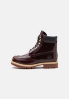 TIMBERLAND Auliniai batai su raišteliais šokolado spalva / vyšninė spalva