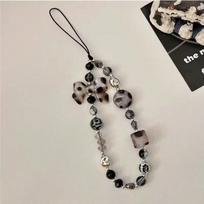 A fashionable mobile phone lanyard adorned with leopard print bow and bead decorations, used as an anti lost phone lanyard Polyester Fiber gray